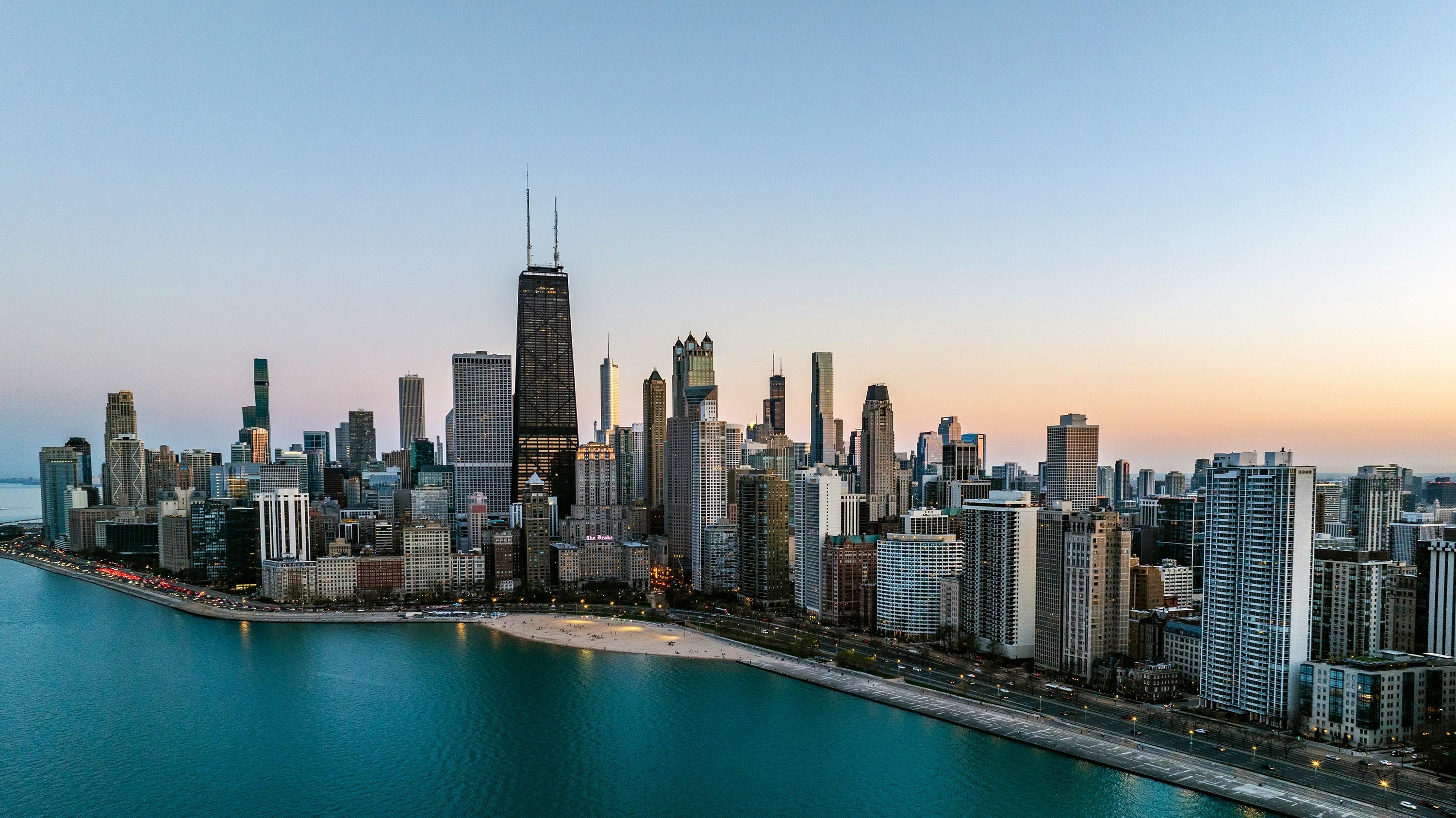 an aerial view of a large city next to a body of water by Ricky Beron courtesy of Unsplash.